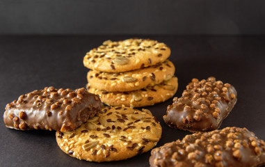 Appetizing sweet dessert with chocolate and oatmeal for morning fragrant coffee on black background