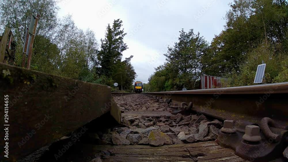 Poster passenger train runs over passes over a camera placed between the rails