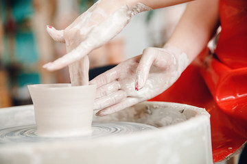 Turkish master paints and cuts clay plate patterns. Concept craft