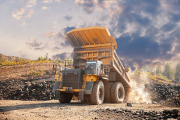 Obraz premium Open pit mine industry, big yellow mining truck for coal anthracite