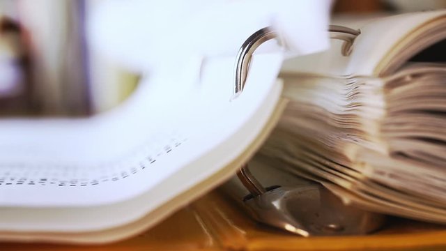 Turning pages of ring binder