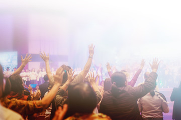 Soft focus of Christian worship with raised hand,m