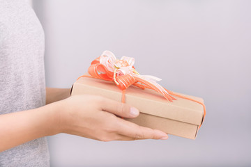 Gift box in hand for giving on white background