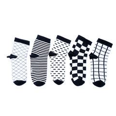 white and black  socks in the cage and stripes or polka dot on a white isolated background