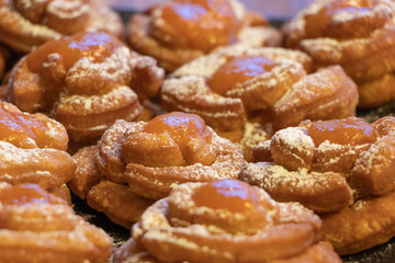 Hungarian home made pastry called rózsafánk rose pastry or doughnuts after frying with powdered sugar and apricots marmalade topping 