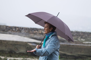 woman with umbrella walking in the rain