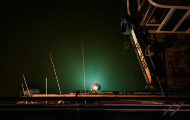 fishermen fishing at night in a boat in Vietnam