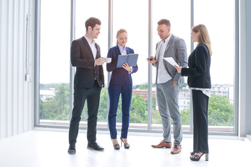 Fototapeta premium Business people or colleague standing meeting and talking in office, professional executives coworkers discussion and brainstorming