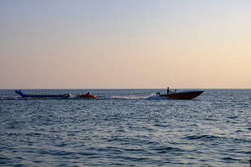 Riding on the Black Sea on an inflatable banana with an attached cable to the boat