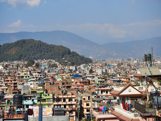 Fototapeta premium View of the streets, houses and the surrounding hills of Kathmandu, between the tourist district of Thamel and the Swayambhu stupa. Nepal.