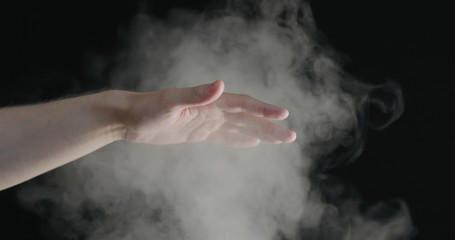 man hand playing with water mist