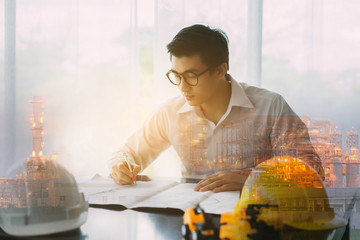 Double exposure Asian architect man working with laptop and blueprints,engineer inspection in workplace for architectural plan,sketching a construction project,Business concept