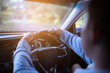 Hands on the steering wheel ,male driving car with modern dvd,radio,gps. Vintage filter,selective...