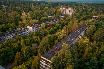 aerial view of the lost city of Pripyat. a lot of empty concrete floors overgrown with trees....