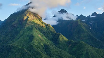 Hoang Lien National Park. Zoom in timelapse of the running clouds in mountains with river and rice terraces on the foreground, north Vietnam. - Powered by Adobe