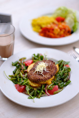 Fried chop on a pillow of vegetables