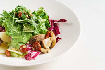 salad with mushrooms on the white