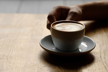 a cup of coffee in the hands. soft light