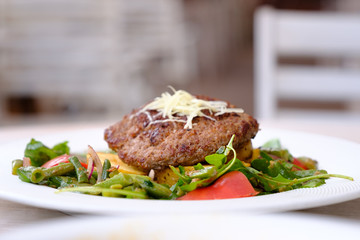Fried chop on a pillow of vegetables