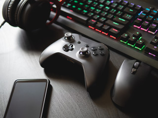 gamer workspace concept, top view a gaming gear, mouse, keyboard, joystick, headset, mobile...