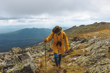 young active man in green hat yellow coat spending time on travelling, young archaeologist...