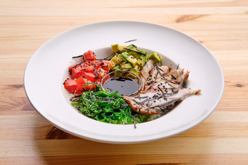 Unagi sashimi rice bowl with avocado, seawed, tomato and soy sauce