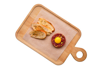 Classic steak tartare with egg and garlic bread