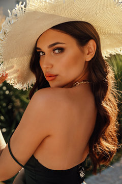 Beautiful Woman With Dark Hair In Elegant Dress Posing In Summer Garden