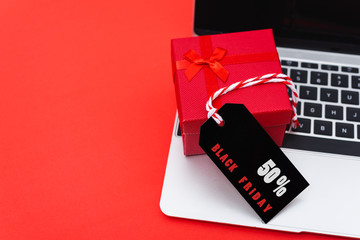 Online shopping, Promotion Black Friday Sale text on black tag with computer laptop and gift box