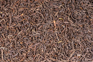 Black tea leaves background. Abstract food textures. Close up