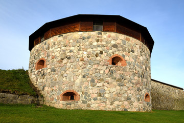 Medieval fortress on coast of famous lake Vanajavesi in old Hameenlinna, Finland. Round gun turret