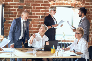 Colleagues going upcoming trade. Adult blonde man wear blue suit and adult blonde woman correct...