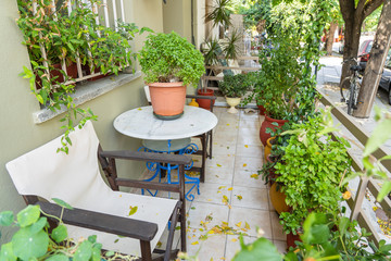 Table and chairs in the street courtyard next to the house. Kos island, Greece