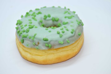 Doughnut with green frosting and green icing crumble on top