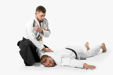 Two caucasian men are practicing aikido on the tatami (isolation path included) - obrazy, fototapety, plakaty