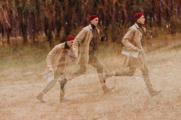 Multiple exposure. Traveler in a raincoat and a red knitted hat. Loneliness. Psychology