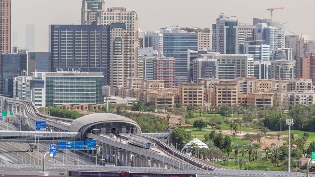 Dubai Golf Course with a cityscape of Gereens and tecom districts at the background aerial timelapse. Traffic on sheikh zayed road with junction and metro station