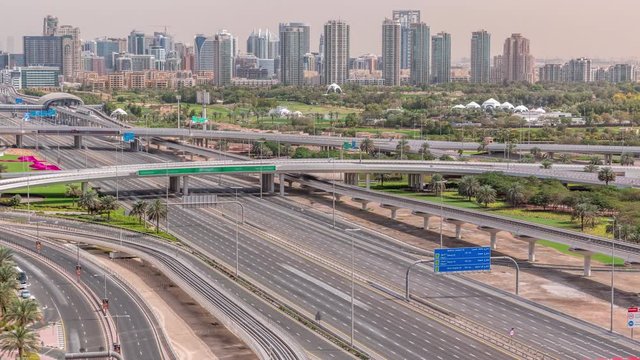 Dubai Golf Course with a cityscape of Gereens and tecom districts at the background aerial timelapse. Traffic on sheikh zayed road with junction