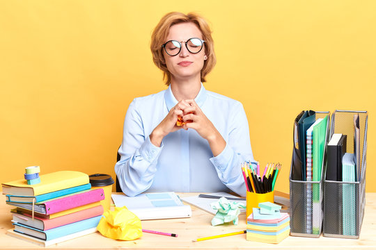 woman with closed eyes trying not to worry, be nervous, close up portrait, isolated yellow background, indurance concept