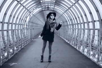 Young adult girl in the architectural tunnel