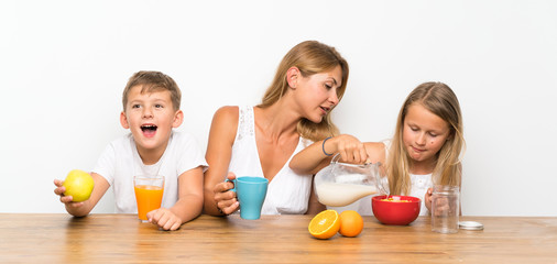 Obraz na płótnie Canvas Mother with her two children having breakfast