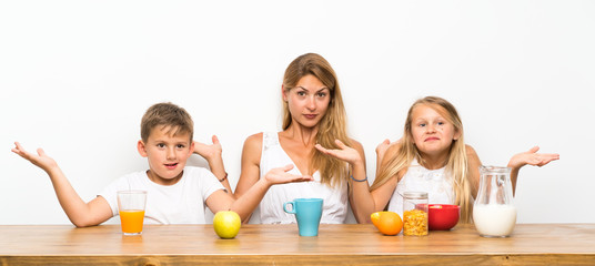 Mother with her two children having breakfast and  having doubts