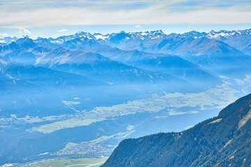 Obraz premium Mountain landscape in Austria, cloudy, forests, rocks, city in the mountains, summer