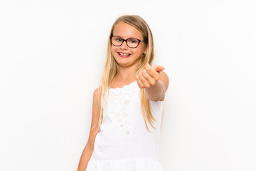 Little girl over isolated white wall doing coming gesture