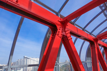 Metal constructions. Red painted metal. Blue sky outside the windows