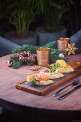 Bruschetta on wood table over pine branch. Christmas served  table