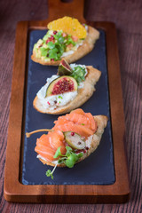 Bruschetta on wood table over pine branch. Christmas served  table