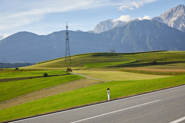 Fototapeta na wymiar Mountain road in Germany, between green fields and mountain landscapes