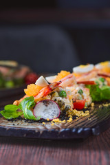 Salad of shrimp, green peas, tomatoes and radish on a white plate, food styling