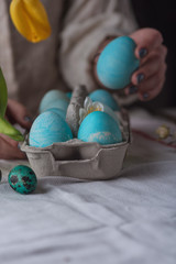 Woman hand taking one of easter egg